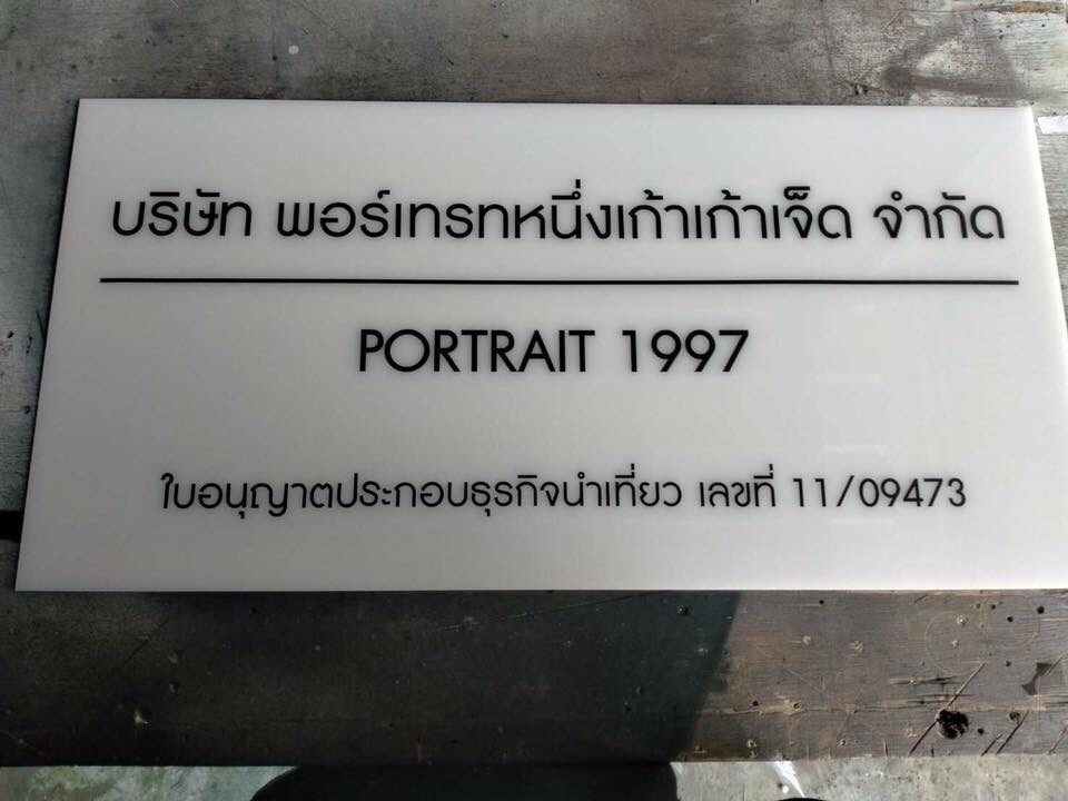 ป้ายอะคริลิค ติดสติ๊กเกอร์ตัวอักษร บริษัท พอร์เทรทหนึ่งเก้าเก้าเจ็ค จำกัด